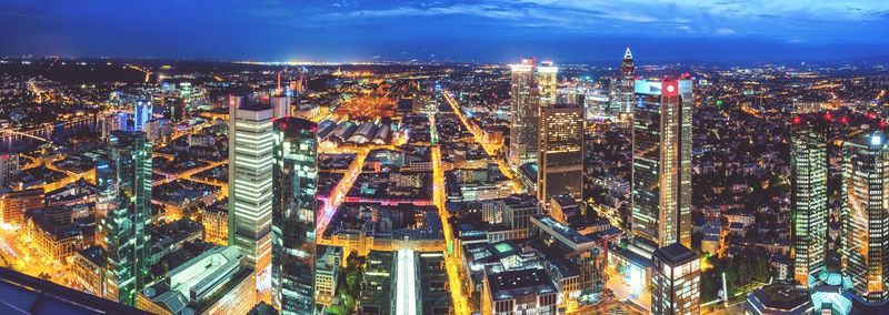 High angle view of city lit up at night