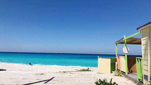 Scenic view of beach against clear blue sky