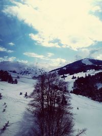 Scenic view of snow covered mountains against sky