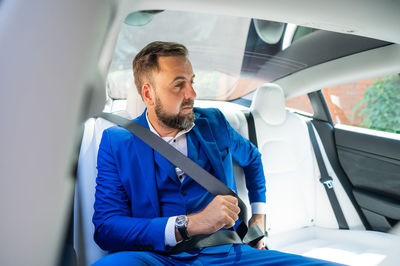 Portrait of man sitting in car