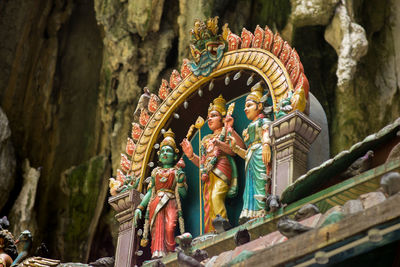 Low angle view of statue against temple building