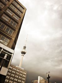 Low angle view of buildings against cloudy sky