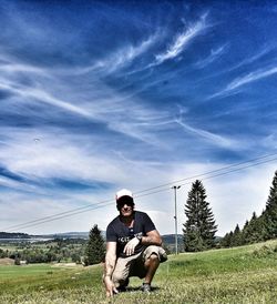 Full length of man sitting on field