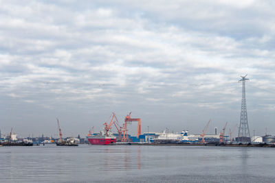 Commercial dock by sea against sky