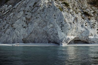 Scenic view of sea by mountain