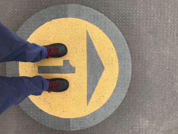 Low section of man standing on footpath