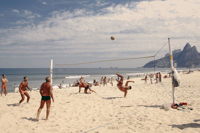 People on beach against sky