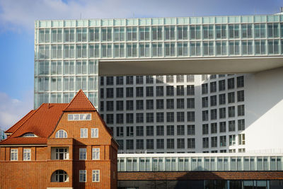 Low angle view of building against cloudy sky