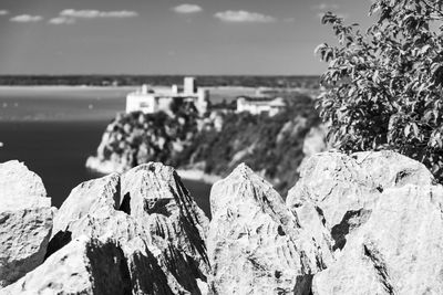 Panoramic view of rocks on beach against sky