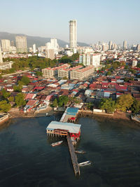 Scenic view of river by buildings against sky