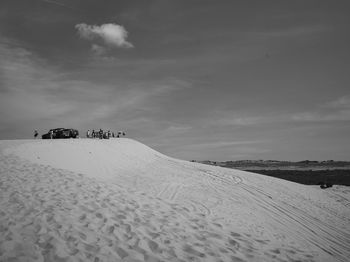 Scenic view of snow covered field against sky