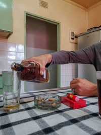 Midsection of man preparing food in kitchen