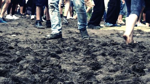 Low section of people standing on tiled floor