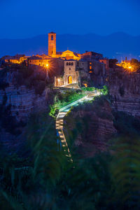 Illuminated buildings against sky at night