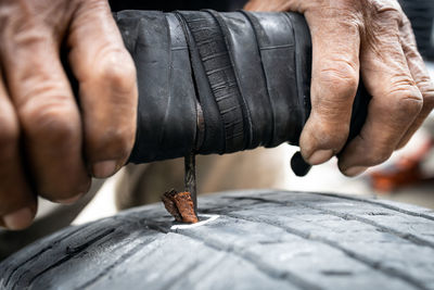 Midsection of man working on wood