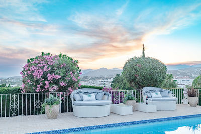 A pair of seashell outdoor sofas surrounding a swimming pool along the costa del sol