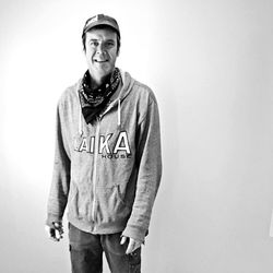 Portrait of young man standing against white background