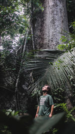 Rear view of man sitting in forest