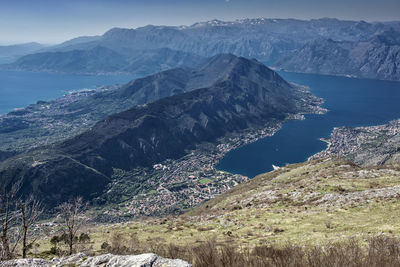 Scenic view of sea and mountains against sky