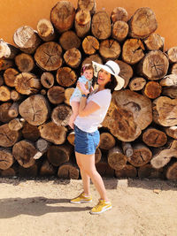 Full length of woman standing on logs