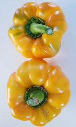 Close-up of yellow bell peppers against white background