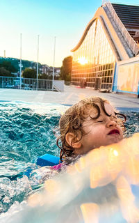 Portrait of siblings in swimming pool