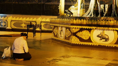 Rear view of man sitting in temple