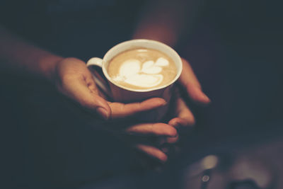 Close-up of hands holding coffee cup