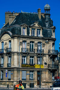 Low angle view of building against blue sky