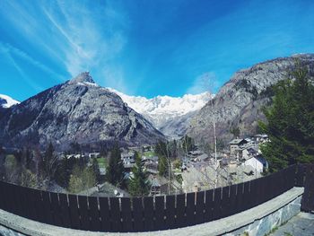 Scenic view of mountains against blue sky