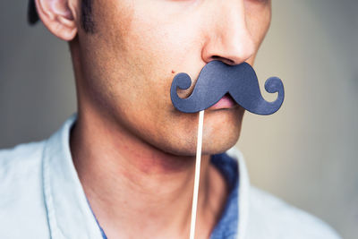 Close-up of man with mustache prop