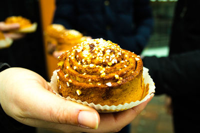 Close-up of hand holding sweet swedish bun