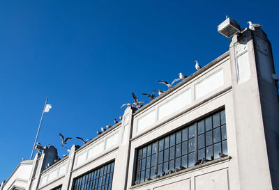 Low angle view of building against clear blue sky