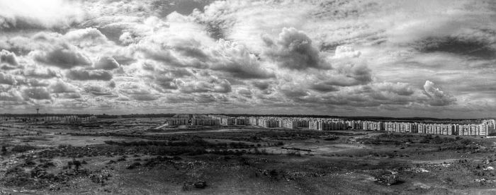 Scenic view of landscape against cloudy sky