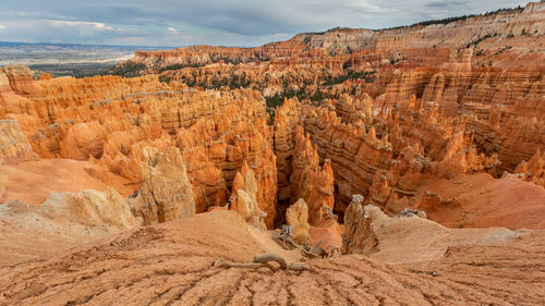 Scenic view of rock formations against cloudy sky