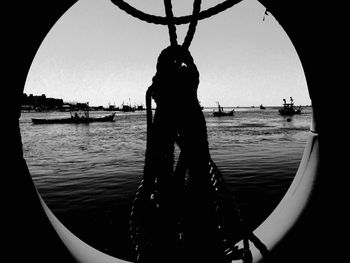 Silhouette of man in sea against clear sky