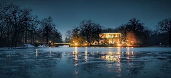 Scenic view of lake against sky at night