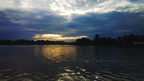 Scenic view of lake against cloudy sky