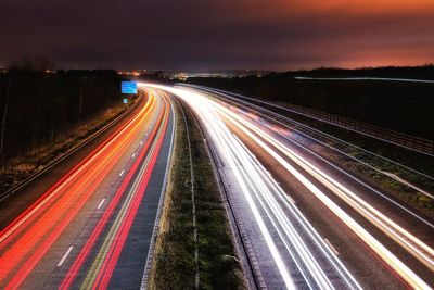 High angle view of light trails on highway at night