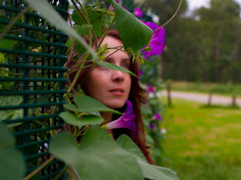 Portrait of girl against purple plants looking elegant 