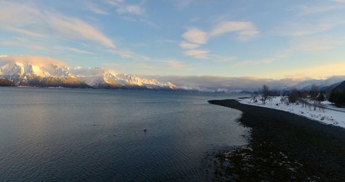 Scenic view of snowcapped mountains against sky during sunset