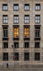 Walking under a surveillance camera by a building in berlin