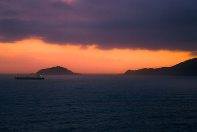 Scenic view of sea against orange sky