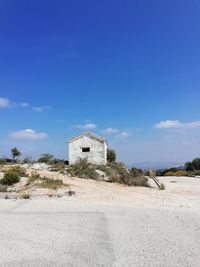 Built structure on beach against blue sky