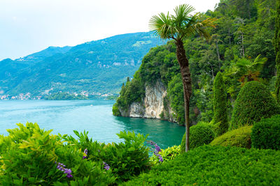 Scenic view of sea and mountains against sky