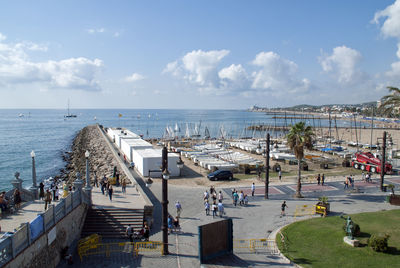 High angle view of people at sea shore against sky