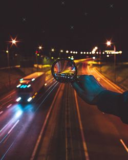 Blurred motion of man on illuminated road at night