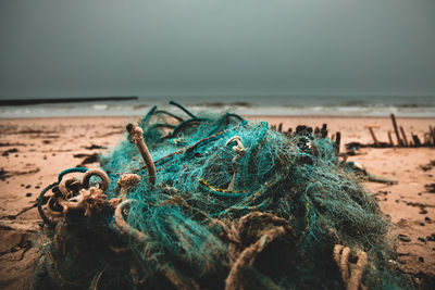 Close-up of fishing net on beach