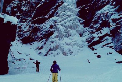 Woman standing on snow covered landscape