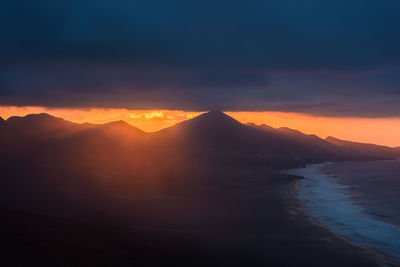 Scenic view of sea against sky during sunset at fuerteventura. jandia hills and playa de cofete 